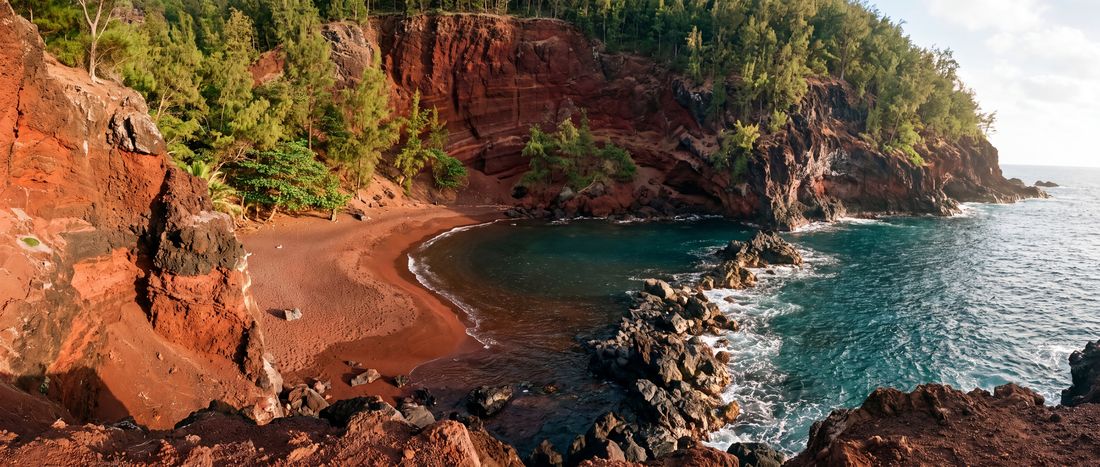 Wide view of Kaihalulu Red Sand Beach, Hana, Maui.