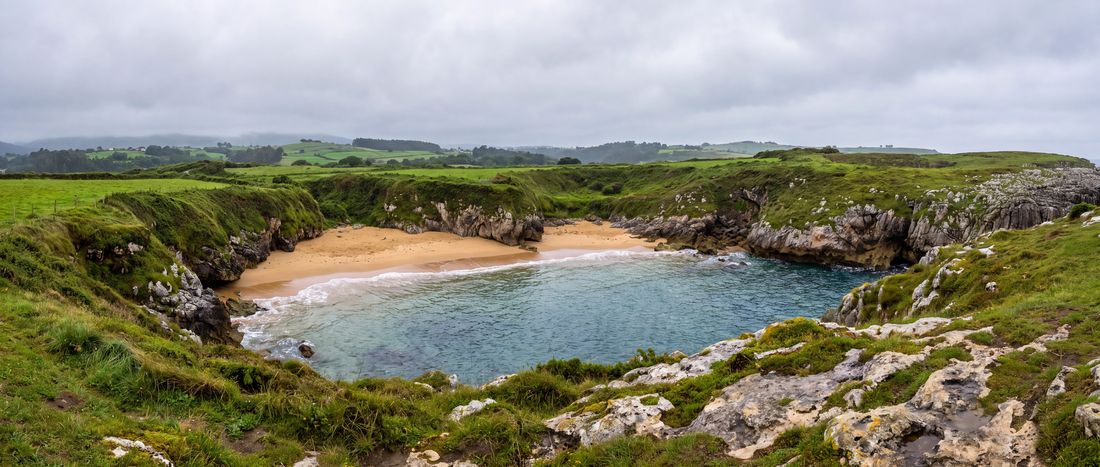 Wide view of Playa de Gulpiyuri, Llanes, Asturias.