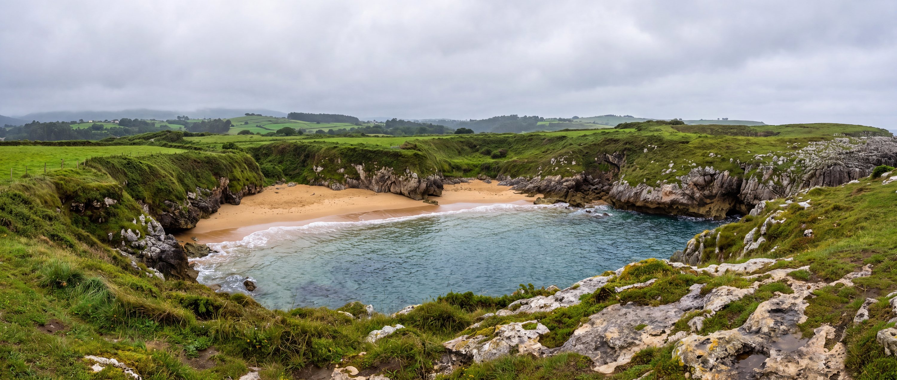 Wide view of Playa de Gulpiyuri, Llanes, Asturias.
